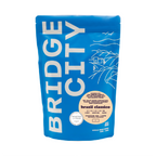 Bridge City Coffee Brazil Classico dark roast coffee bag featuring rich, chocolatey specialty coffee from Minas Gerais, Brazil.