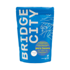 Bridge City Coffee Peru Lucero medium roast coffee bag, featuring single-origin Peruvian coffee with tasting notes of caramel and milk chocolate.